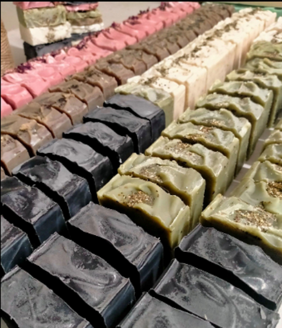 Rows of handmade soap bars curing in the Coconut Luxe studio